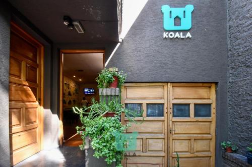 
a door leading to a building with a door open at Koala Hostel in Mendoza
