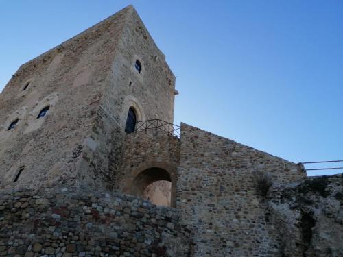 a large stone building on top of a hill at Momaliar House in Campofelice di Roccella