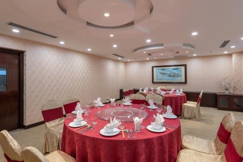 a conference room with tables and chairs with red table cloth at Red River View Hotel in Lao Cai