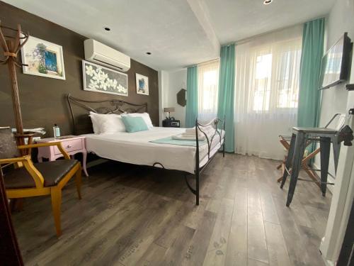 a bedroom with a bed and a desk and a chair at Bertiz Mignon in Bozcaada