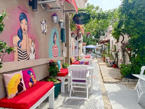 a row of benches on the side of a building at Bertiz Mignon in Bozcaada