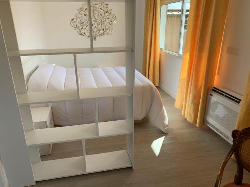 a bedroom with a white bed in a room at Apartamentos Sanjuan in Porriño