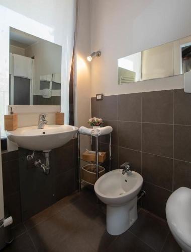 a bathroom with a sink and a toilet at LT - Room's Bed & Living in Monza