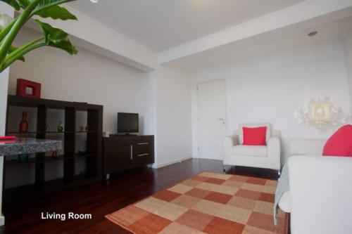a living room with a bed a chair and a television at 2Stay - A2 in Ponta Delgada