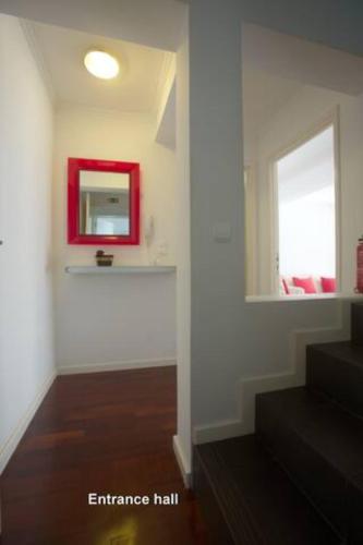 a room with a red mirror on the wall at 2Stay - A2 in Ponta Delgada