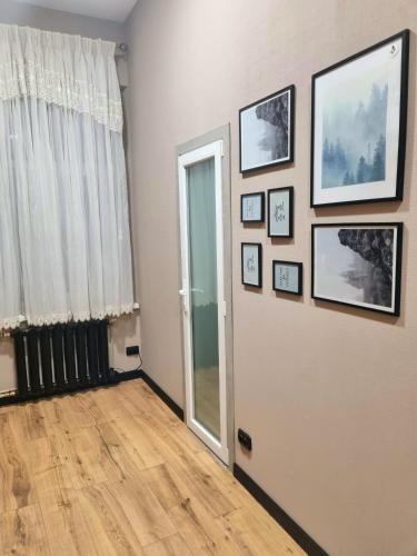 a room with a door and pictures on the wall at Old Town #Menorah #MostCity in Dnipro