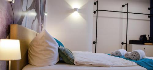 a bedroom with a bed with pillows and a lamp at HOMELY STAY Studio 2 in Munich