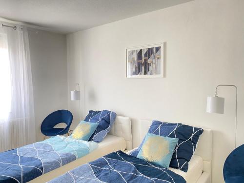 a living room with a couch and blue pillows at Blaue Insel neben Hbf-Duisburg in Duisburg