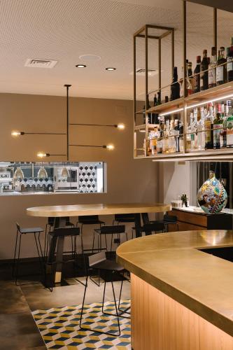 a restaurant with tables and chairs and a counter at Hotel Ristorante Eurossola in Domodossola