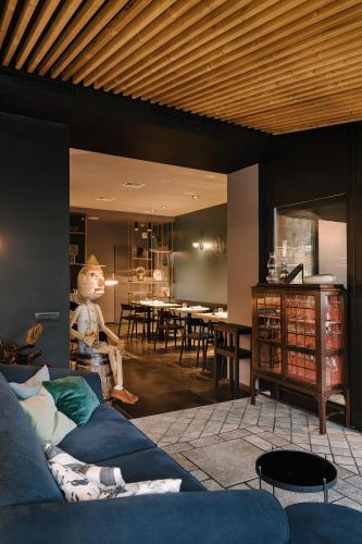 a living room with a blue couch and a table at Hotel Ristorante Eurossola in Domodossola