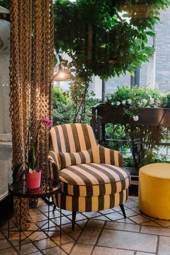 a chair and a ottoman sitting on a patio at Hotel Ristorante Eurossola in Domodossola