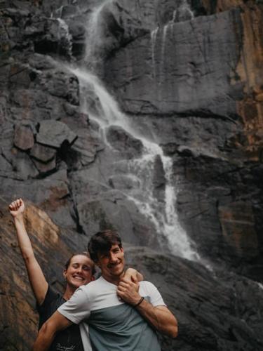 two men are standing in front of a waterfall at Ella Retreat Hotel Glamping Tent For Nature Lovers in Ella