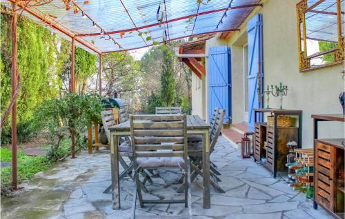 an outdoor patio with a wooden table and chairs at Gorgeous Home In Tourrettes in Tourrettes