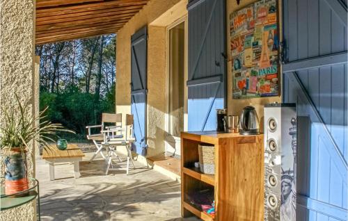 a patio with a refrigerator and a table at Gorgeous Home In Tourrettes in Tourrettes