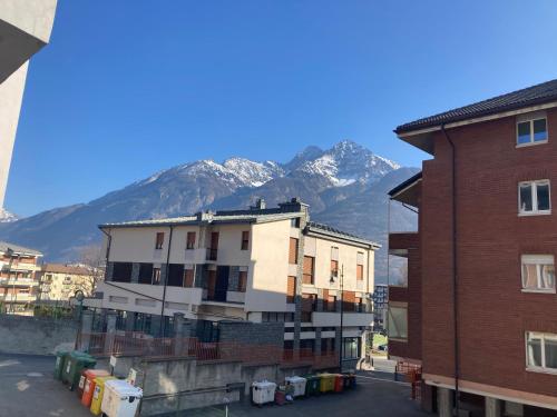 a group of buildings with mountains in the background at A casa di Niki in Aosta