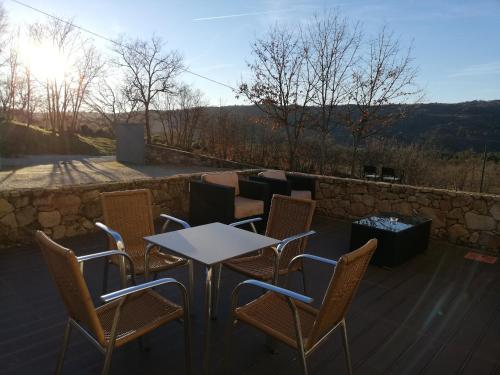 a group of chairs and a table on a patio at Quinta dos Carvalhais - Serra da Estrela in Fornos de Algodres