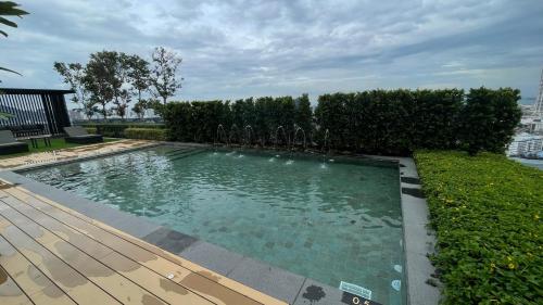 a swimming pool in a yard with a wooden deck at Beacon Executive Suite at Georgetown for 10pax and 2 BED ROOM in George Town