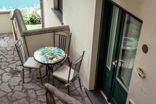 a table and chairs sitting on a balcony at Villa San Cosma in Ravello