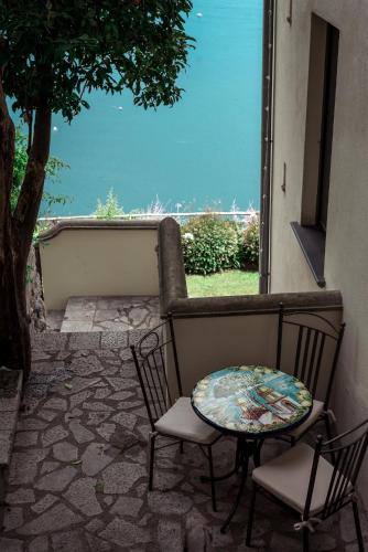 a table and chairs sitting on a patio with a window at Villa San Cosma in Ravello