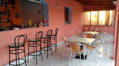 a restaurant with tables and chairs in a room at Elena Pool in Agios Georgios