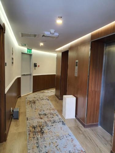a lobby with a hallway with a rug on the floor at Al Salam Hotel in Kuwait