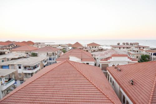 a view of roofs of houses and the ocean at Grand Hotel Ras Elbar in Ras El Bar