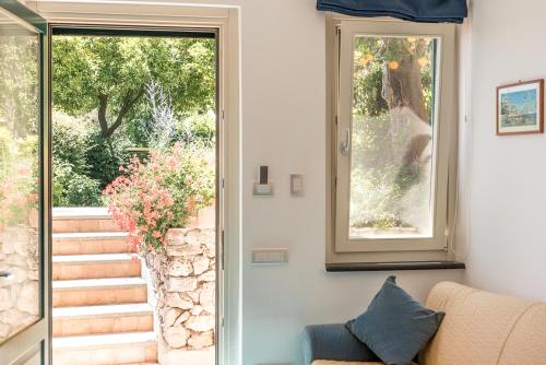 a living room with a couch and a window at Villa San Cosma in Ravello