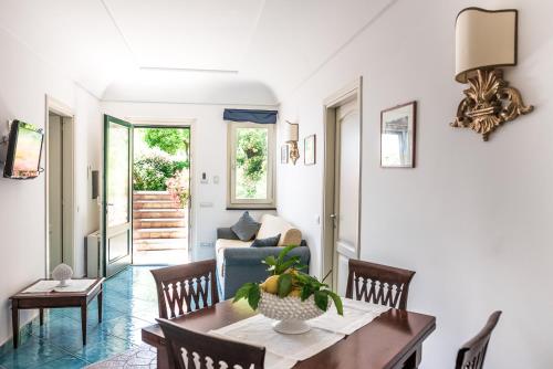 a living room with a table and a couch at Villa San Cosma in Ravello