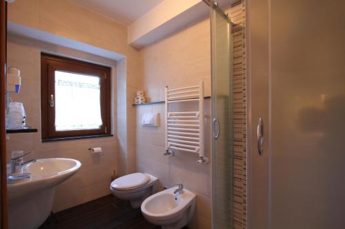 ヴィッレッタ・バッレーアにあるHotel Il Vecchio Pescatoreのバスルーム(洗面台、トイレ付)、窓が備わります。
