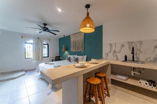 a bedroom with a bed and a kitchen with a counter at Casa Yako in Playa del Carmen
