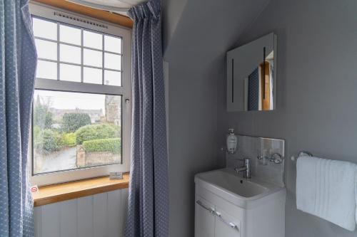 a bathroom with a toilet and a window at Firtree Bed and Breakfast at Galvelbeg House in Crieff