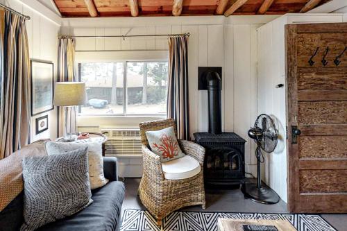 a living room with a couch and a wood stove at Sprucewold Beach House in Boothbay Harbor