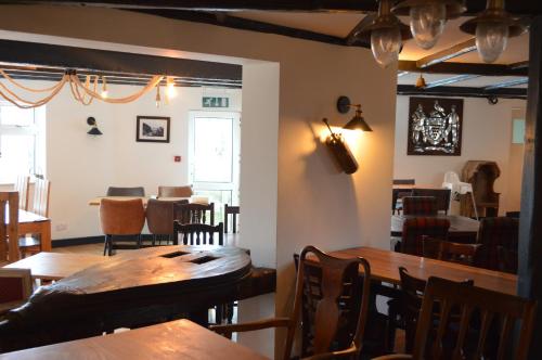 a dining room with wooden tables and chairs at The Cornishman Inn in Tintagel