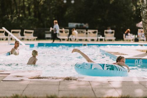 a group of people in a swimming pool at Zamek Łeba Resort & Spa in Łeba