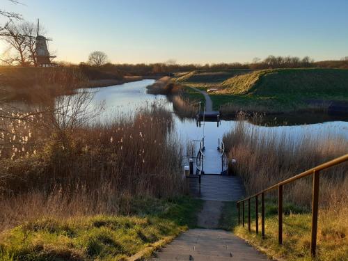 a view of a river with a bridge and a tower at Studio Bourbon in Veere