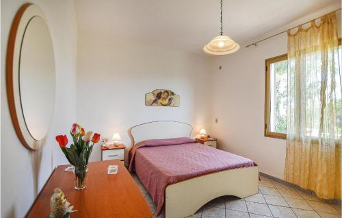 a bedroom with a bed and a vase of flowers on a table at Casa Marinella in Castelvetrano Selinunte