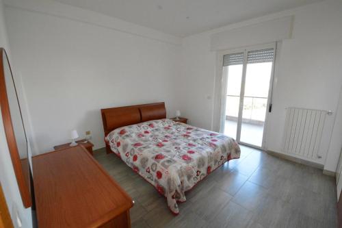 a bedroom with a bed with a floral bedspread at Appartamento Vistamare 20 in Bari