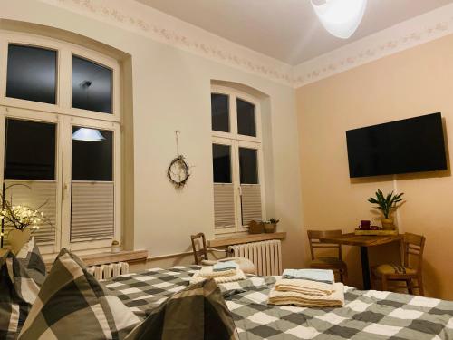 a bedroom with a bed and a flat screen tv at St.Moritz -Quadenschönfeld in Möllenbeck