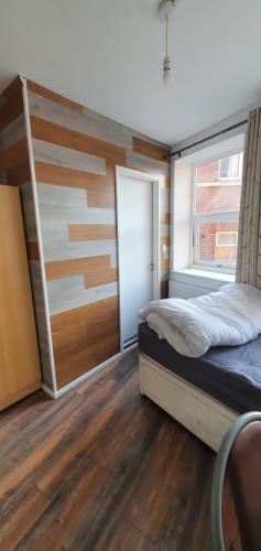 a bedroom with a bed and a window at En suite single bedroom, close to city centre in Sheffield