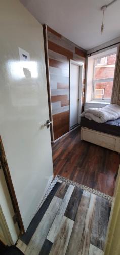 a room with a door and a bed and a window at En suite single bedroom, close to city centre in Sheffield