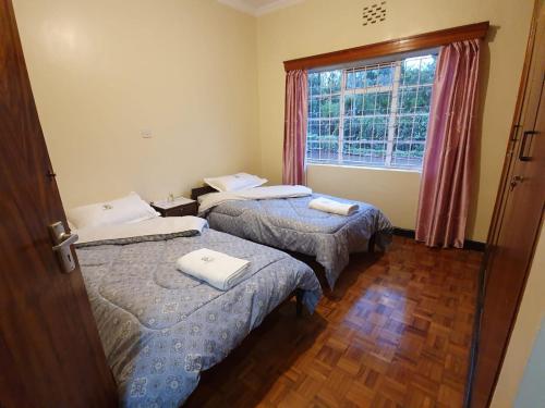 Ένα ή περισσότερα κρεβάτια σε δωμάτιο στο Thayo Place