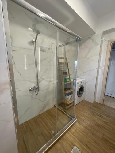 a shower in a room with a washing machine at Martimi Apartments - 200M from Drapanias Beach - Pool - Hot Tub - Sauna - BBQ in Kissamos