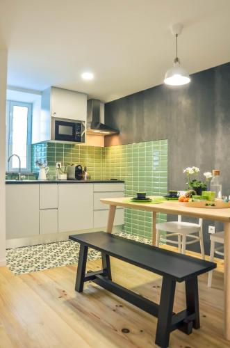 a kitchen with a table and a bench in it at Atlantic Furnas in Furnas