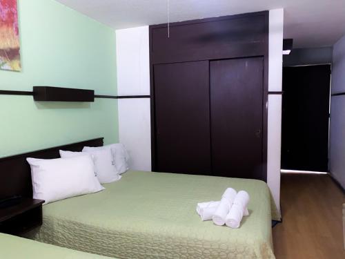a bedroom with a bed with white towels on it at Hotel Trevi in Salamanca
