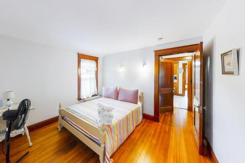 a bedroom with a bed and a chair in it at Murray Hill Waterside in East Boothbay