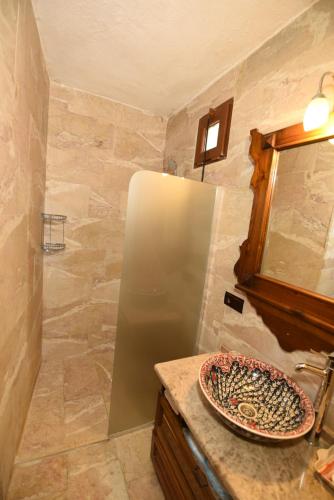 a bathroom with a refrigerator and a sink at Canela Cave Hotel - Cappadocia in Goreme