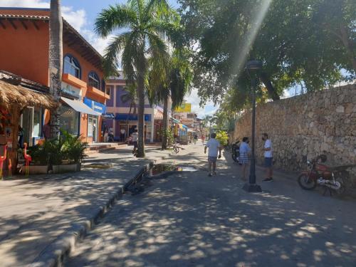 a group of people walking down a street at PLAYA BLANCA BED AND BREAKFAST in Bayahibe