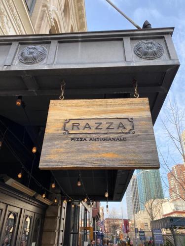 a sign for a pizza entrance on a building at Riverhouse Extended Stay Apartment in Jersey City