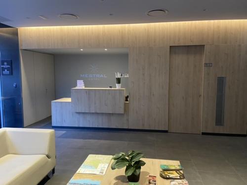 a lobby with a waiting area with a couch and a table at Hotel Mestral Perelló in Perelló