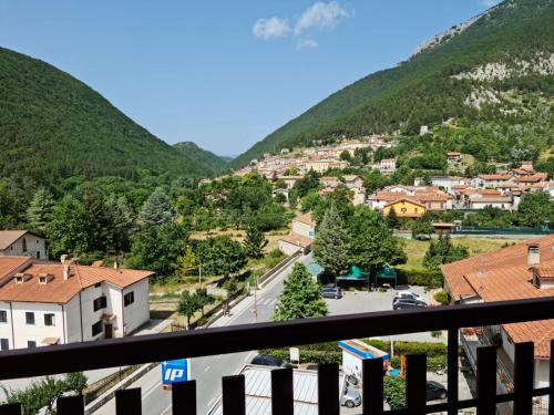 a view from the balcony of a town in the mountains at luxury lake in Villetta Barrea